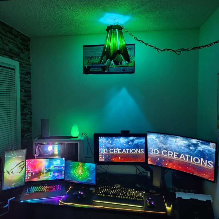 RGB-lit five-monitor creative workstation with Huion drawing monitor, custom-built PC, and immersive setup for 3D design, digital art, and animation
